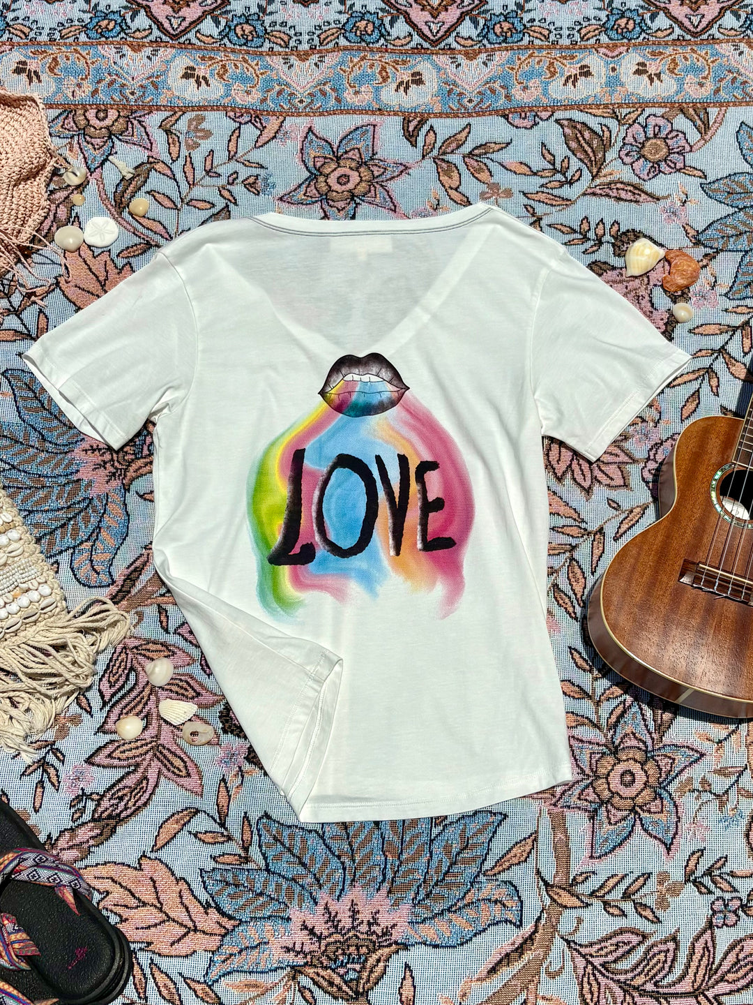white v-neck tee with rainbow streaks, mouth, and 'LOVE' depiction on back.