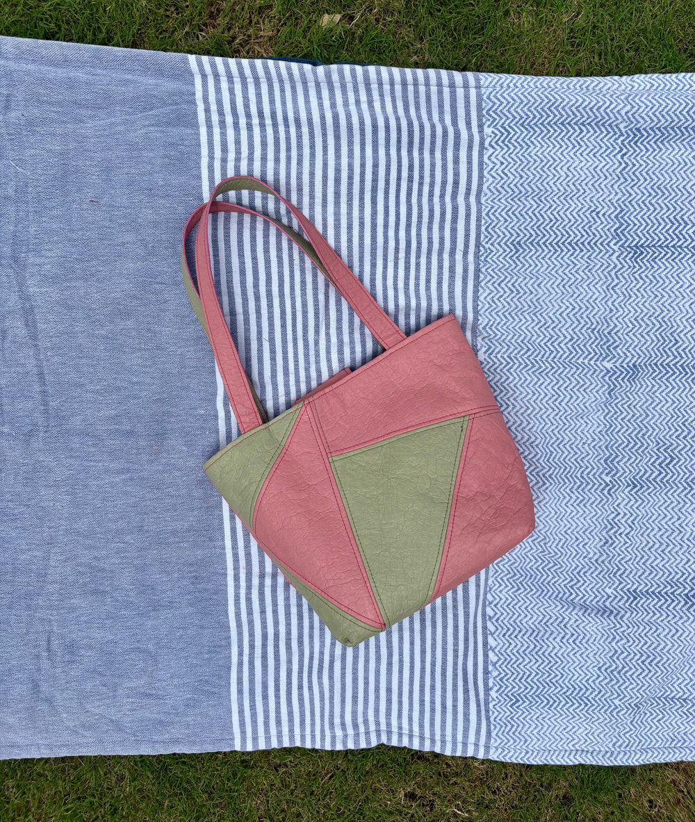 medium pink and green colorblock tote with snap closure.