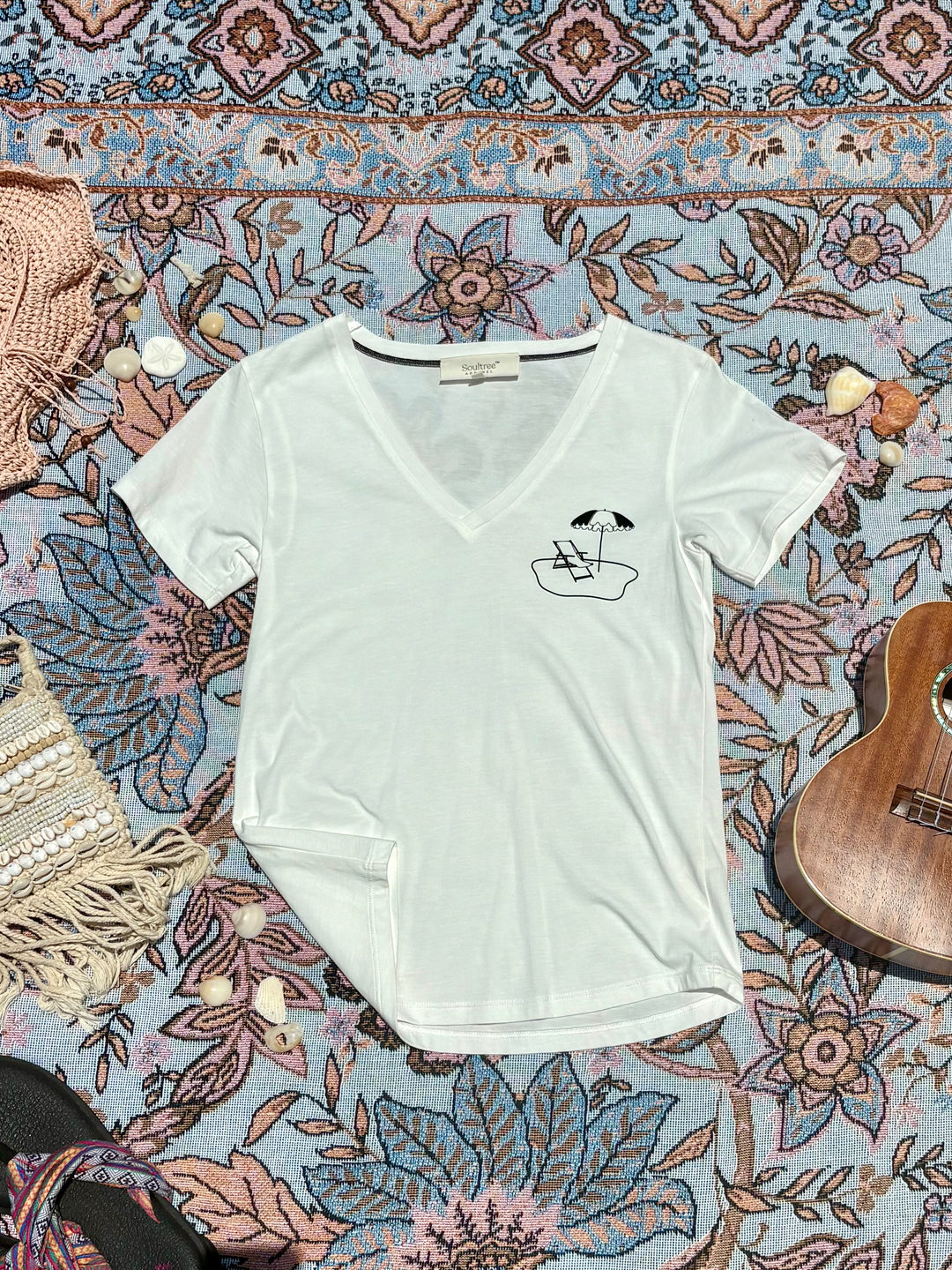 white v-neck tee with beach chair and umbrella sketch on left chest.