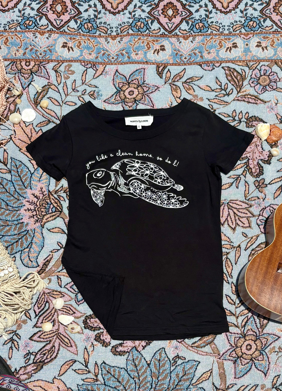 black round-neck tee with turtle and quote depiction on front.