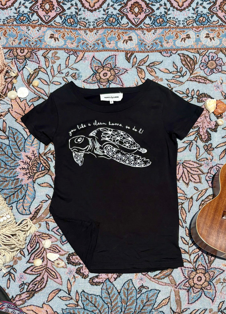black round-neck tee with turtle and quote depiction on front.