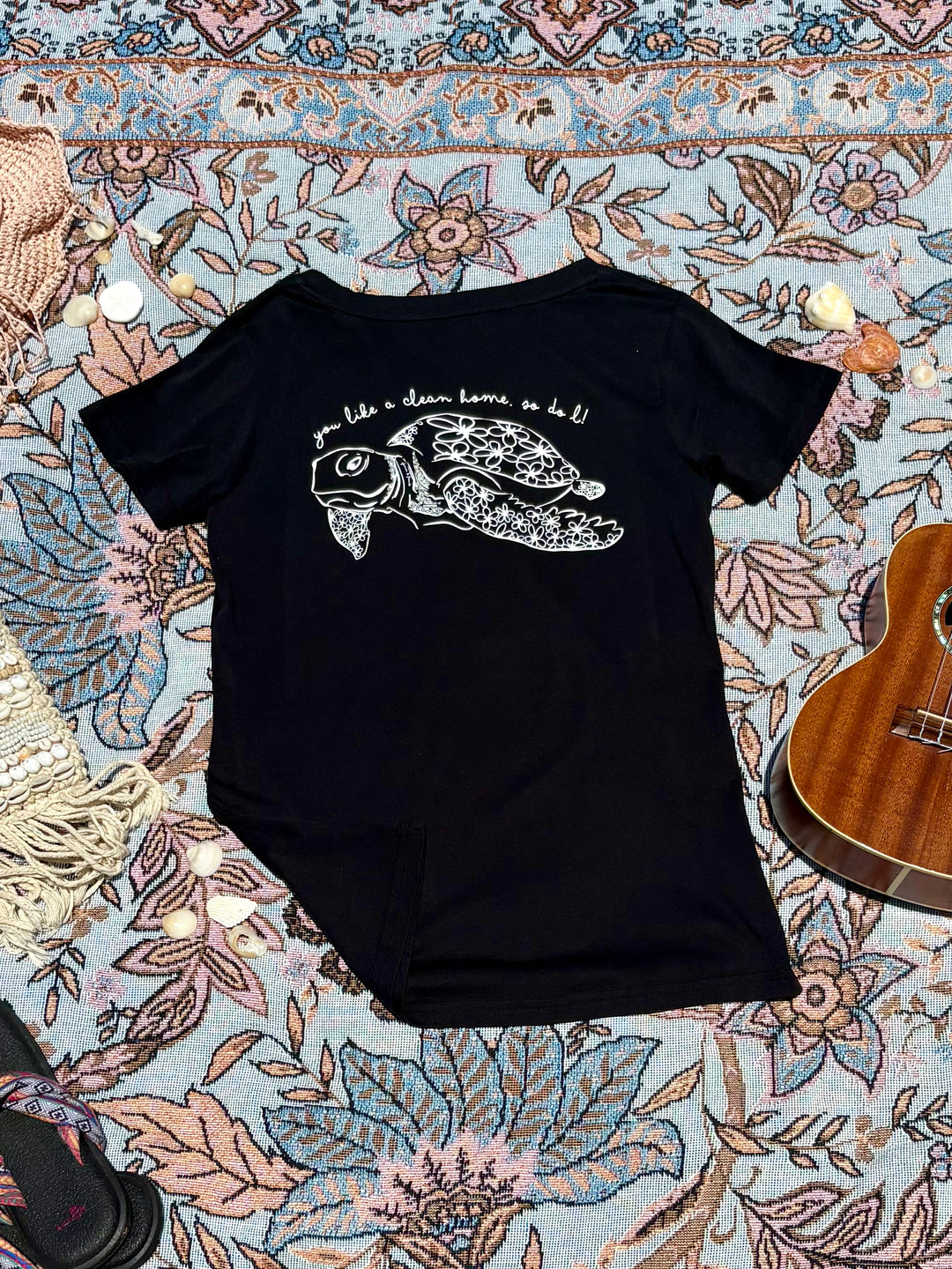 black round-neck tee with turtle quote and depiction on back.
