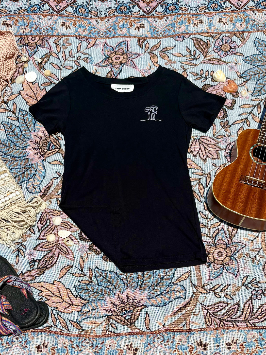 black round-neck tee with mushroom embroidered sketch on left chest.