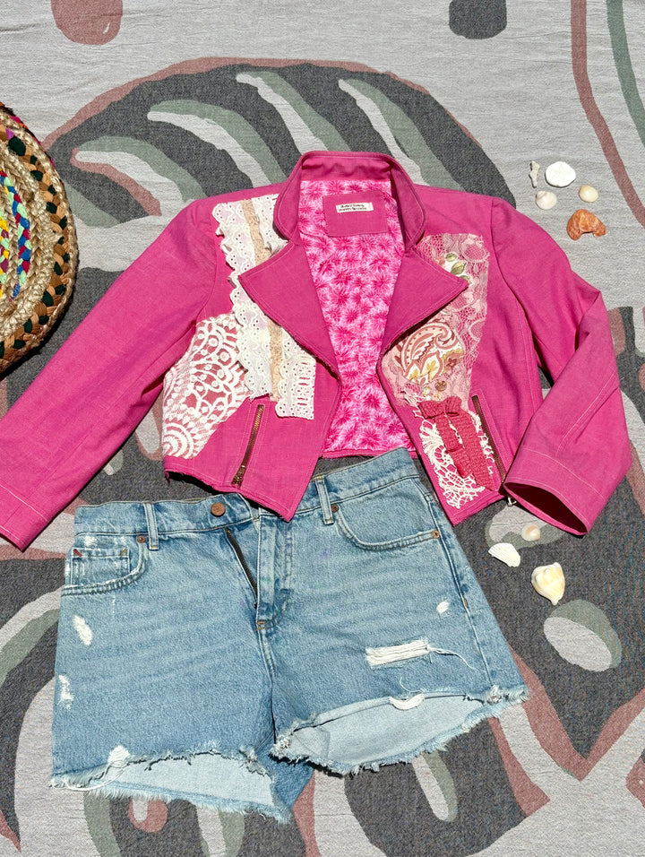 cropped pink biker jacket with various lace patchwork and butterfly details.