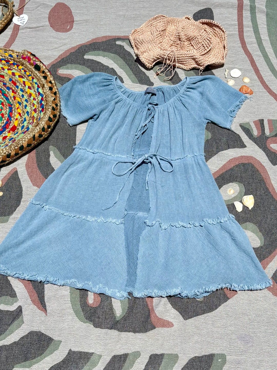 knee-length slate blue cover up with open front and ties to secure it.