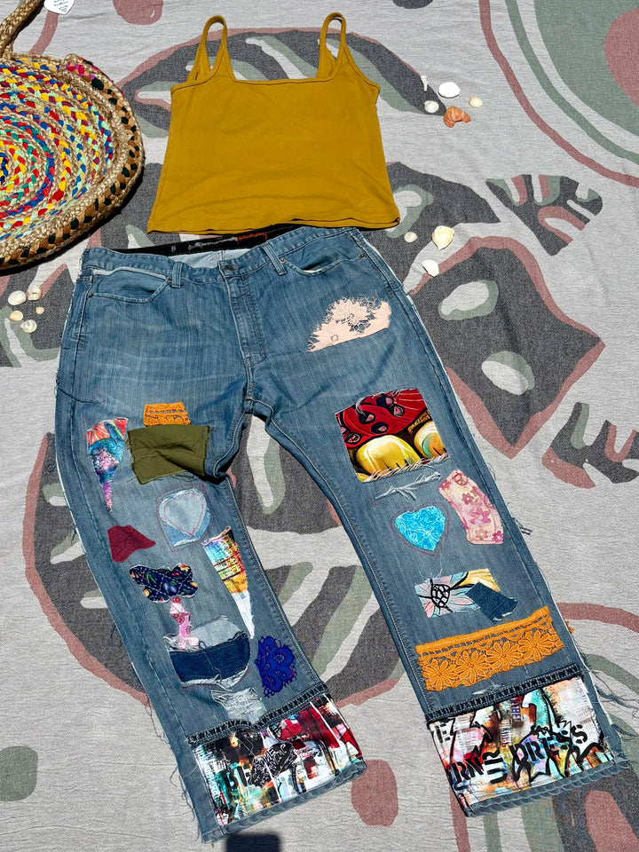 medium wash baggy jeans with patchwork of various colors, patterns, and materials.