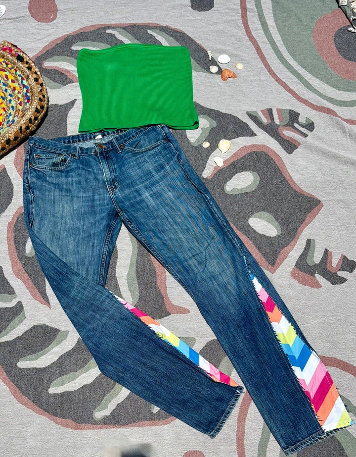 bootcut dark wash jeans with rainbow fabric sewn in to the lower sides.