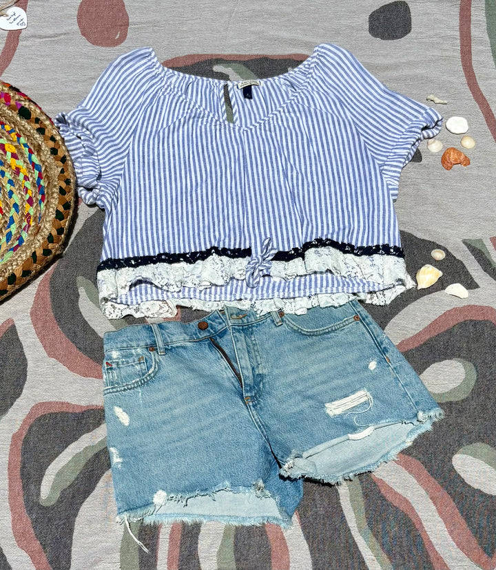 blue and white striped blouse with lace trim and a waist tie.